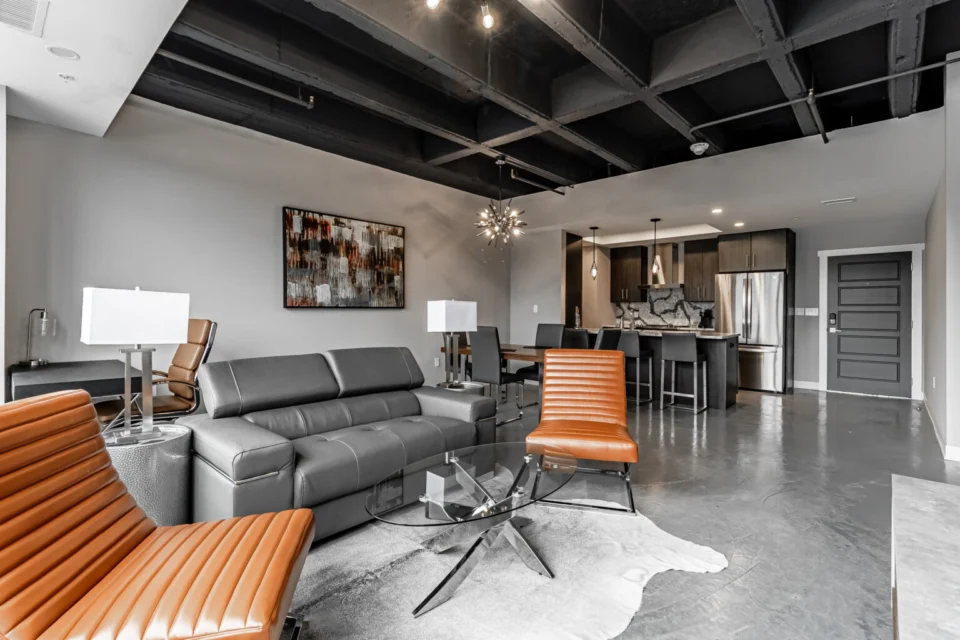 Furnished apartment living area and kitchen with a seamless grey FlowStone floor