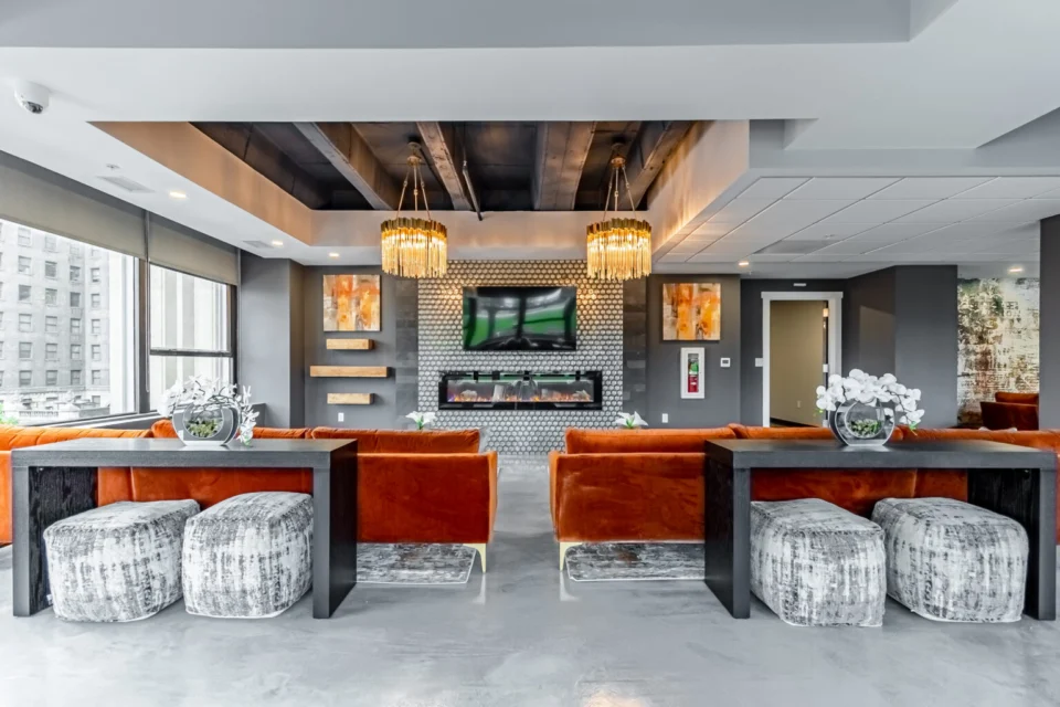Clubhouse lounge with velvet seating and a seamless grey FlowStone floor